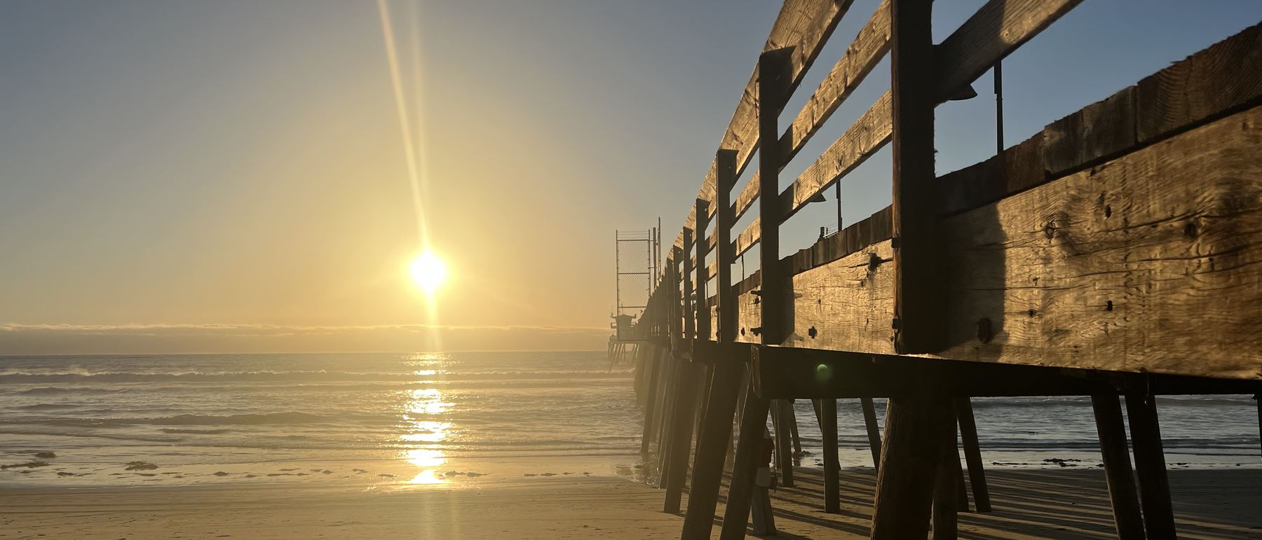 Beneath the Imperial Beach Pier at sunset, San Diego County, California